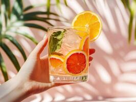 Refreshing citrus drink with garnishes and vibrant background photo
