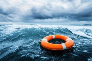 Lifebuoy floating in turbulent ocean waters under a cloudy sky photo