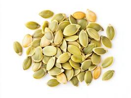 Neatly arranged pumpkin seeds on white for healthy snacking photo
