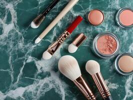 Makeup tools and products arranged on green marble surface photo
