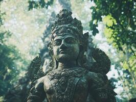Ancient stone statue surrounded by lush tropical greenery photo