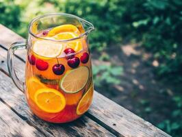 Refreshing fruit punch served in a glass pitcher outdoors photo