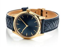 Stylish gold wristwatch with blue leather band on a reflective surface photo