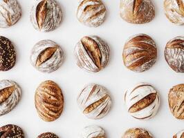 Freshly baked artisan bread varieties arranged on a white surface photo
