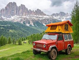 Camping adventure in the mountains with a red off-road vehicle photo