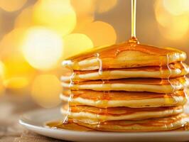Stack of fluffy pancakes drizzled with syrup on a warm morning photo