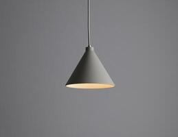 Modern pendant lamp hanging against a gray wall photo