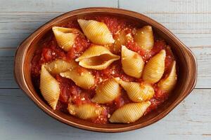 Delicious stuffed pasta shells served in tomato sauce photo