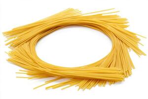 Long strands of uncooked spaghetti displayed on a white background photo