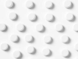White circular tablets arranged in a neat pattern on a smooth surface photo