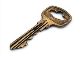 Old metal key resting on a white background for creative use photo