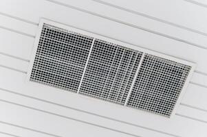 Air conditioner in a room with white walls photo