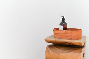 A wooden stool with a bottle holder on top photo
