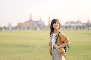 Asian woman in a field with a building in the background photo