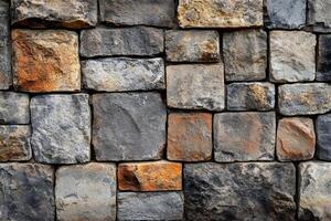 Solid stone wall showing various colors and textures creating a rustic background photo