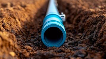 Installing large diameter blue water pipe in ditch during infrastructure project photo