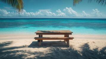 Wooden picnic table on a beautiful tropical beach with turquoise water photo