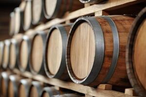 Wine barrels stacked in rows inside a winery cellar aging photo