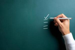 Teacher checking task on chalkboard, completing to do list in classroom photo