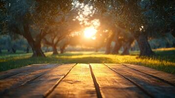 Empty wooden table in olive grove at sunset, perfect background for product placement photo