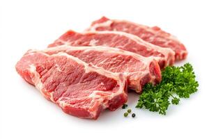 Fresh lamb chops with parsley and peppercorns resting on white background photo