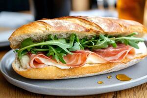Freshly made sandwich with speck ham, mozzarella cheese and arugula is served on a plate photo