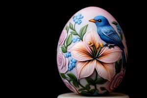 Decorative easter egg featuring bird, lily, and roses on dark background photo