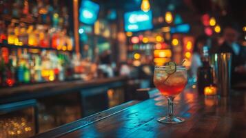 Refreshing cocktail stands on bar counter in blurred pub background photo