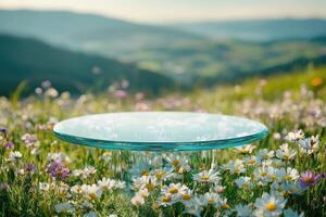 Empty glass podium displaying on blooming wildflower meadow with scenic mountain view in background photo