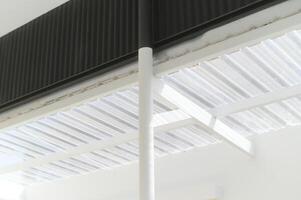 Modern architectural design featuring white structure with corrugated roofing. clean lines and minimalistic style create contemporary aesthetic photo