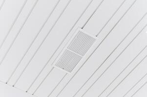 A ceiling vent with a white light above it photo