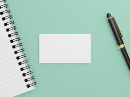 A clean and minimal business card mockup with a black pen and spiral notepad on a flat background. photo