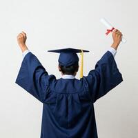 Back view of a graduate with arms raised in victory over a white background photo