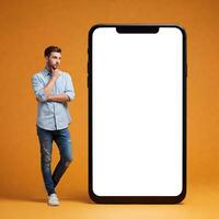 Man standing next to a blank smartphone screen photo