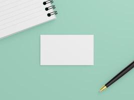 A business card mockup with a simple card, accompanied by a black pen and a spiral-bound notepad. photo