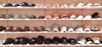 Various of cap hat on the shelf in OH SOME store. Bekasi, West Java Indonesia - March 2 2025 photo