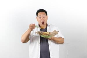 Man enjoying Indonesian Fried Rice with satisfied expression photo