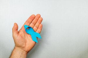 Supporting cancer awareness through symbolic blue ribbon in health campaigns photo