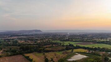 An aerial view of a valley and fields at sunset photo
