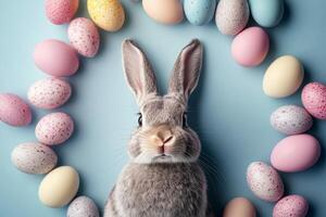 Adorable Easter bunny nestled amidst vibrant painted eggs, set against a soft pastel background with floral elements photo