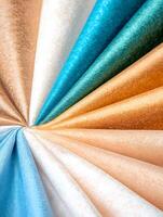 A close up of several different colored fabrics photo