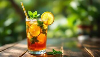 A glass of iced tea with lemon and mint leaves photo