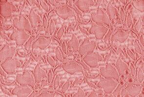 Chic openwork fabric background with pink floral ornaments. Abstract fabric texture. A copy of the space. openwork vintage pattern. photo