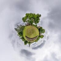 A small planet with a tree and grass photo