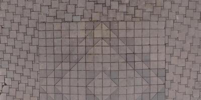A large square tile pattern on the ground photo