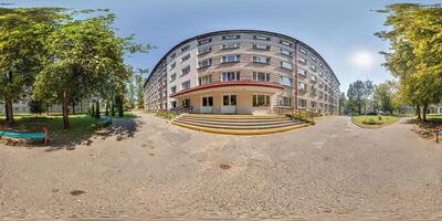 A building with a lot of trees and benches photo