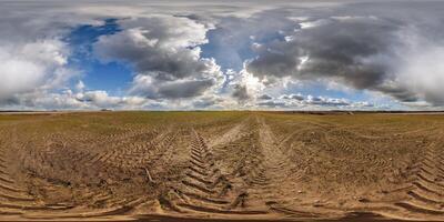spherical 360 hdri panorama on agro field with clouds and sun on blue sky in equirectangular seamless projection, as sky replacement in drone panoramas, skybox game development photo
