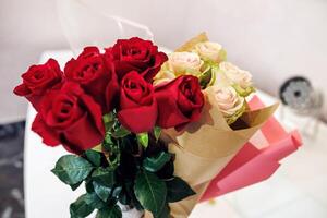 A bouquet of roses sitting on a table photo