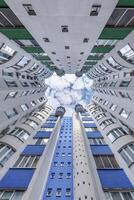 A view up at a building with blue and white windows photo