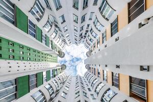 A view up at the top of a building with windows photo